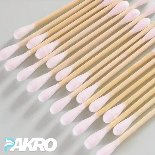 Bamboo cotton swabs with pink tips on a light gray background, featuring the brand 'PAKRO'.