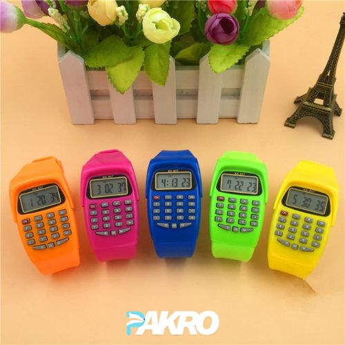 Five colorful calculator watches on a beige surface with a decorative plant and Eiffel Tower model in the background. Pakro Store