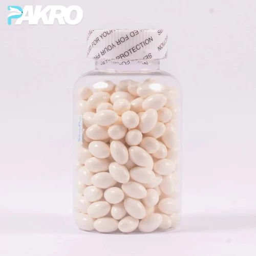 Jar of white oval candies with a white lid on a light pink background, featuring the brand 'PAKRO'.