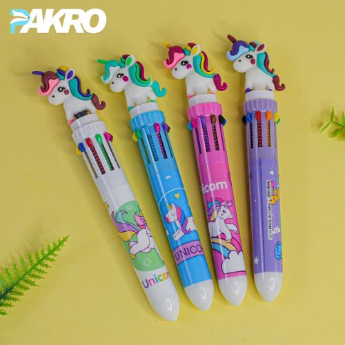 Four colorful pens with unicorn designs on a yellow background