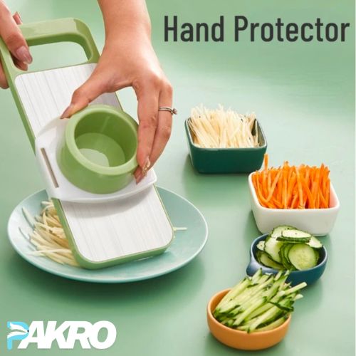 Vegetable slicer with sliced vegetables on a green background, featuring the brand 'PAKRO'.
