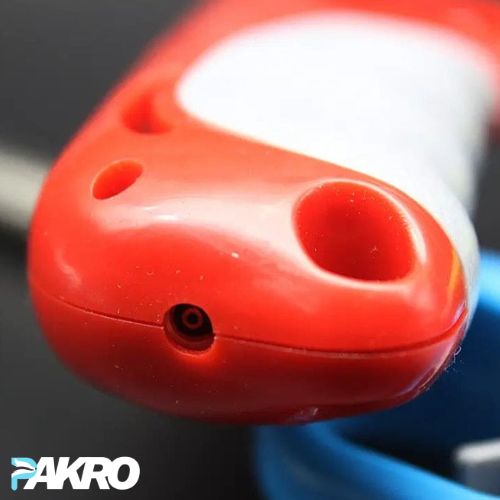 Close-up of a red object with a blurred background, featuring the Pakro Store.