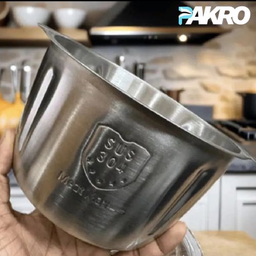 Stainless steel pot held by a hand with 'PAKRO' branding in the background