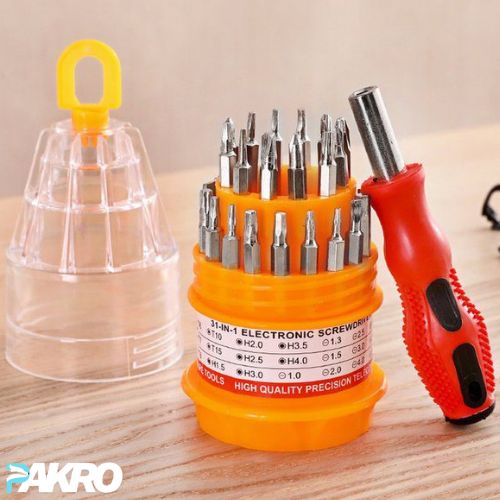 3-in-1 electronic screwdriver set with bits in an orange holder on a wooden surface, featuring the brand 'PAKRO'.