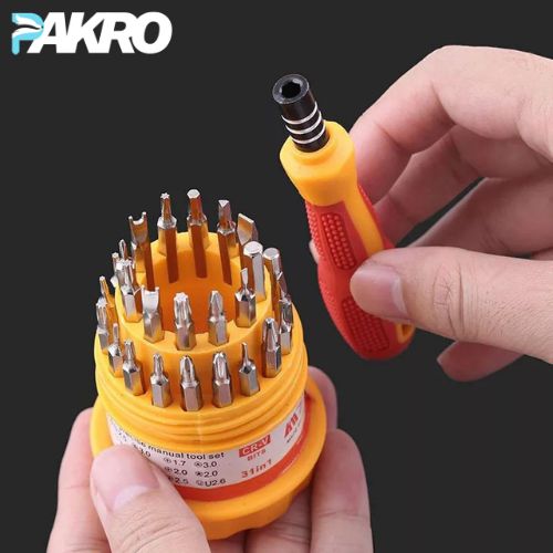 Yellow screwdriver set with multiple bits held by hands against a black background, featuring the brand 'PAKRO'.