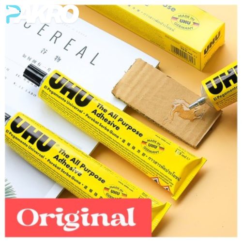 UHU all-purpose adhesive with packaging on a beige surface