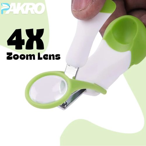 Baby Nail Clipper with Magnifier Zoom Lens, Safety Nail Cutter. Green and white magnifying glass with 4x zoom lens held by a hand, branded 'PAKRO'.