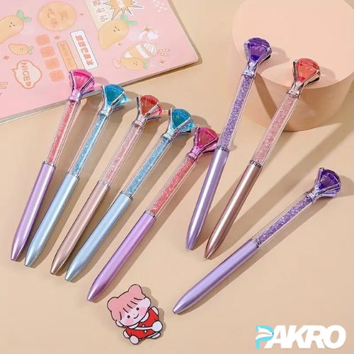 Cute Love Diamond Colorful Crystal Rotating Gel Pens. Colorful pens with gemstone designs on a beige background, featuring the brand 'PAKRO'.