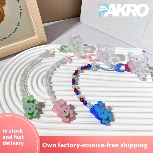 Colorful baby teething toys with cartoon characters on a white surface, branded 'PAKRO'.