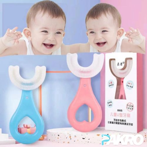Two children smiling behind a blue and pink U-shaped toothbrush with packaging in the background. Car Style U-Shape Silicone 360 Degree Baby Toothbrush