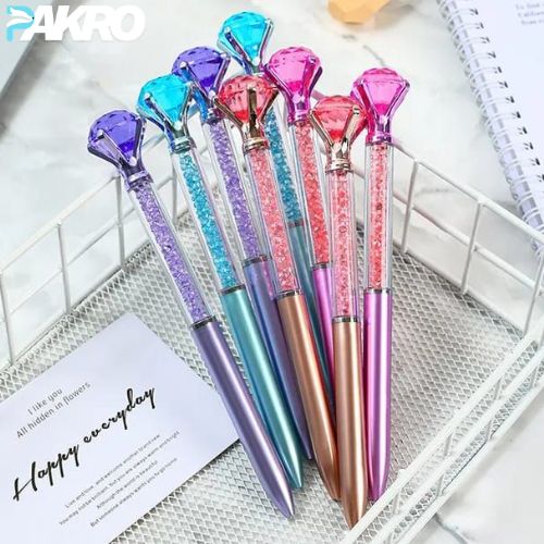 Colorful gel pens with gemstone designs on a white surface